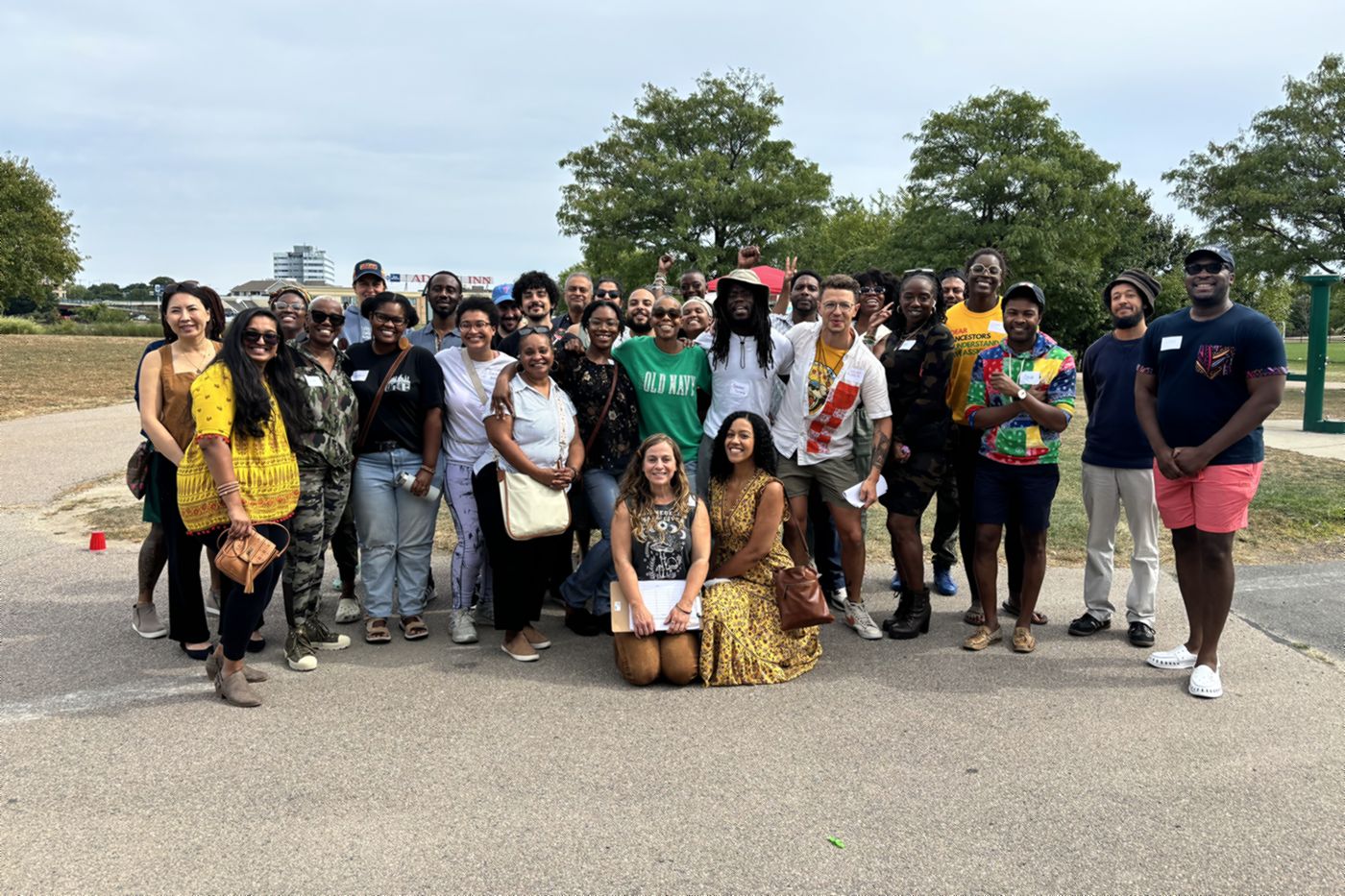 Dozens of EMC community members standing together and smiling at Shroomz N The Hood, the collective&rsquo;s launch gathering in Pope John Paul II Park, Boston.